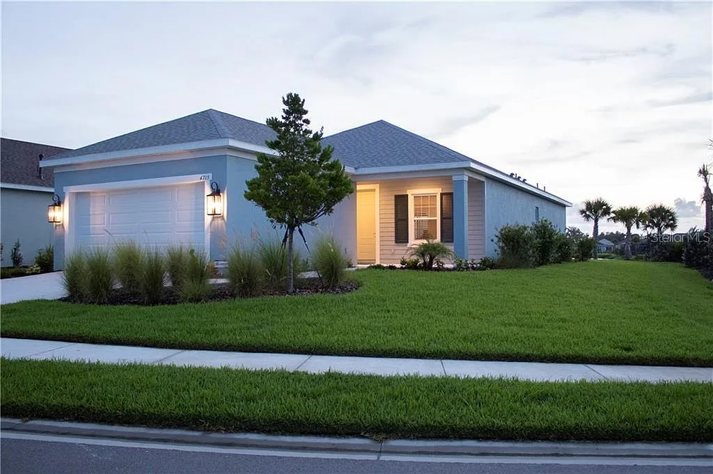 Twilight view of the modern single-story home at 4715 Canoe Creek Ave in Parrish, Florida