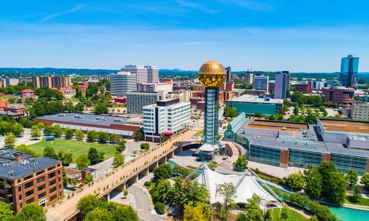 Aerial view of Knoxville with the Tennessee River winding through suburban neighborhoods and downtown at golden hour