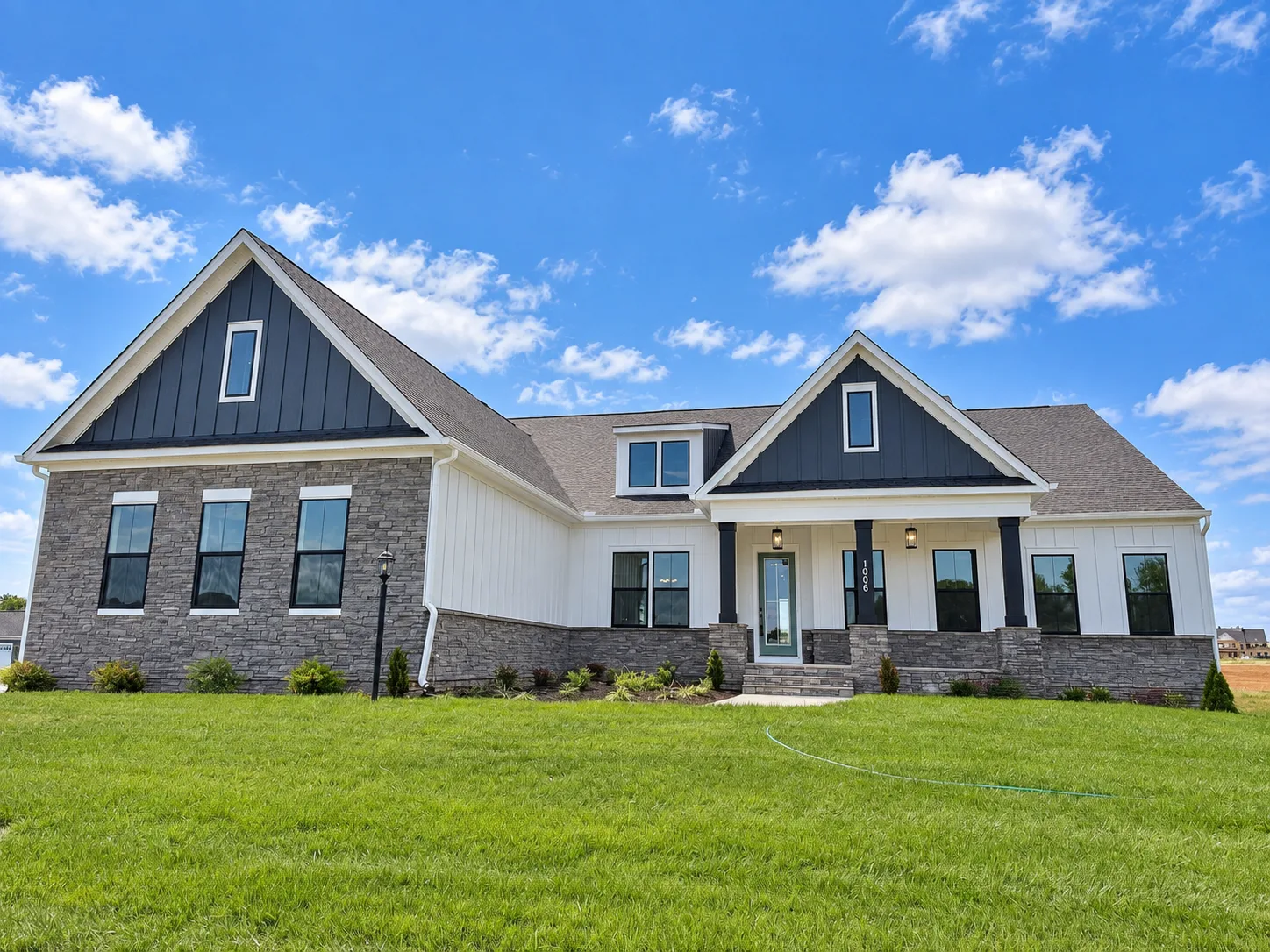 Modern farmhouse front facade of the Torrey quick move-in home at Hampstead by Atlantic Builders in Stafford VA