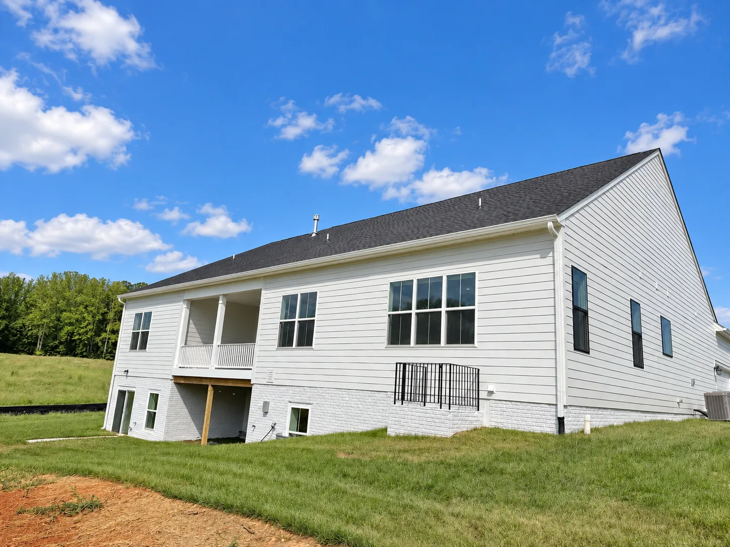 Rear exterior of the Torrey at Hampstead with a raised deck and lower patio