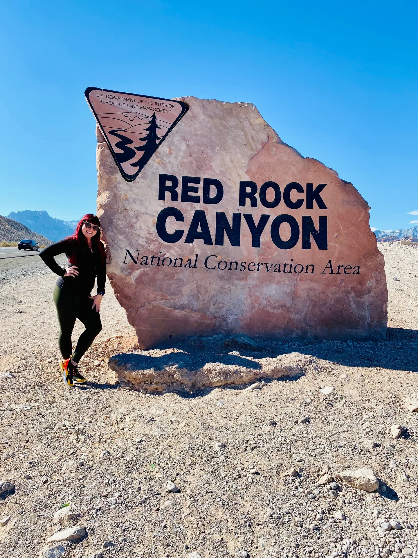 Samantha Medeiros at the Red Rock Canyon National Conservation Area entrance sign