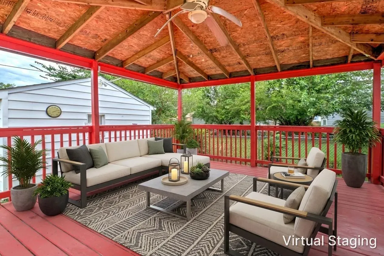 Virtually staged covered back patio at 902 E Maywood Ave with sectional sofa, armchairs, rug, and plants