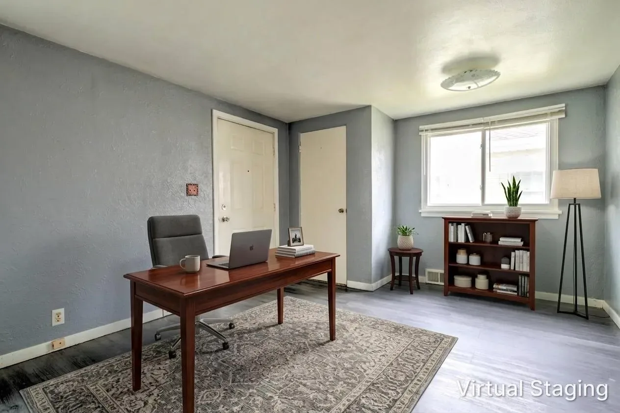 Virtually staged home office version of the grey bedroom with desk, chair, and bookshelf