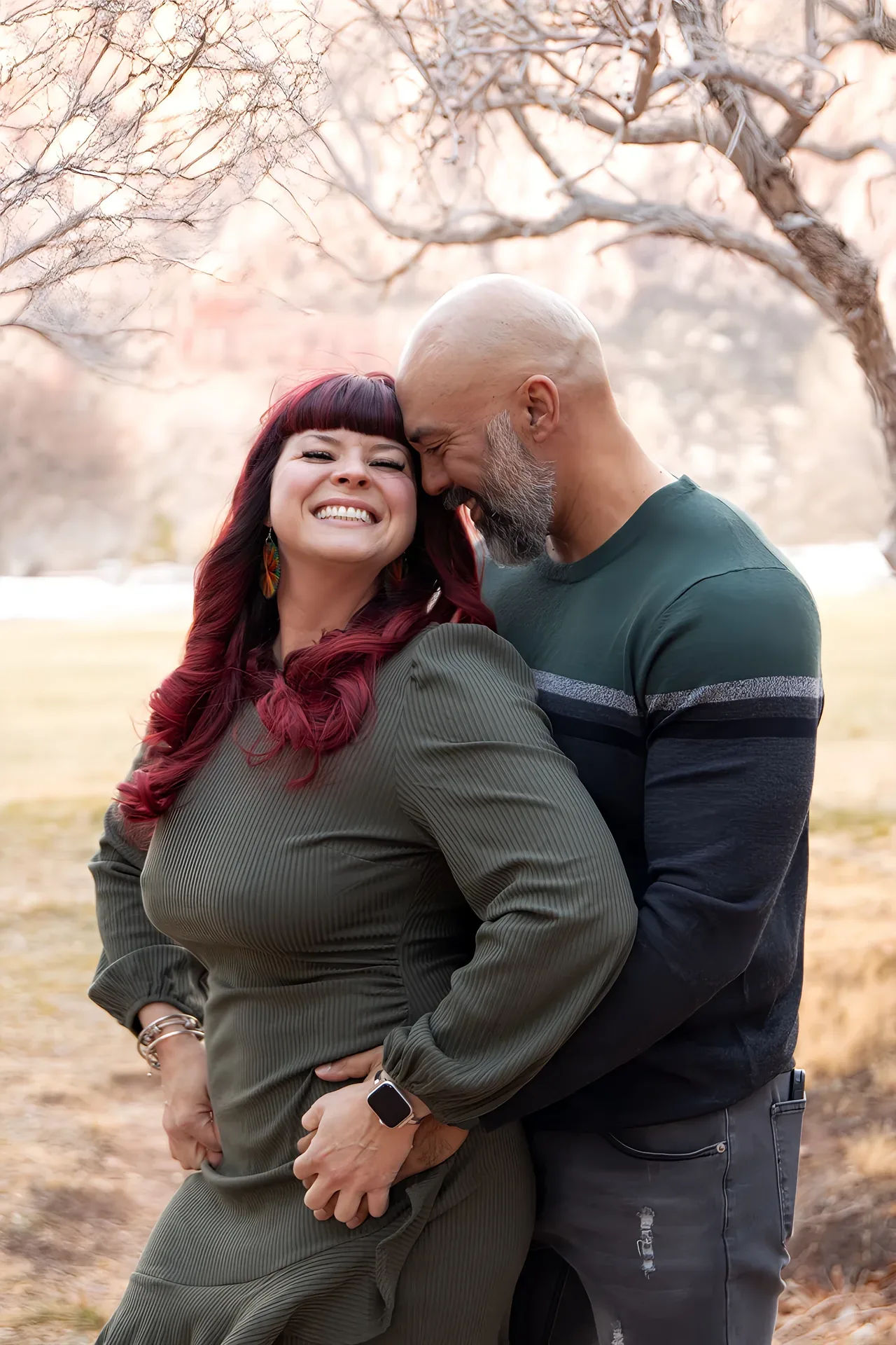 Samantha Medeiros and her husband embracing outdoors with Red Rock Canyon behind them