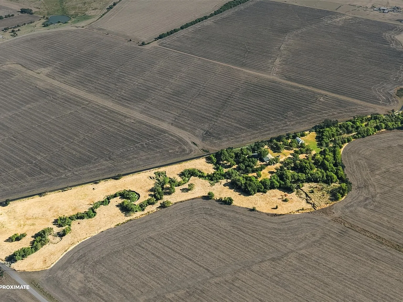 Aerial view of the property and surrounding farmland