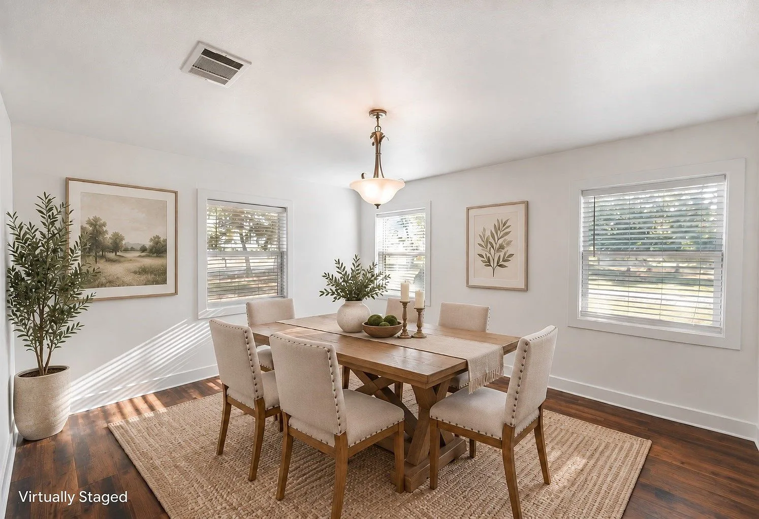 Renovated dining room with dark wood floors and a chandelier