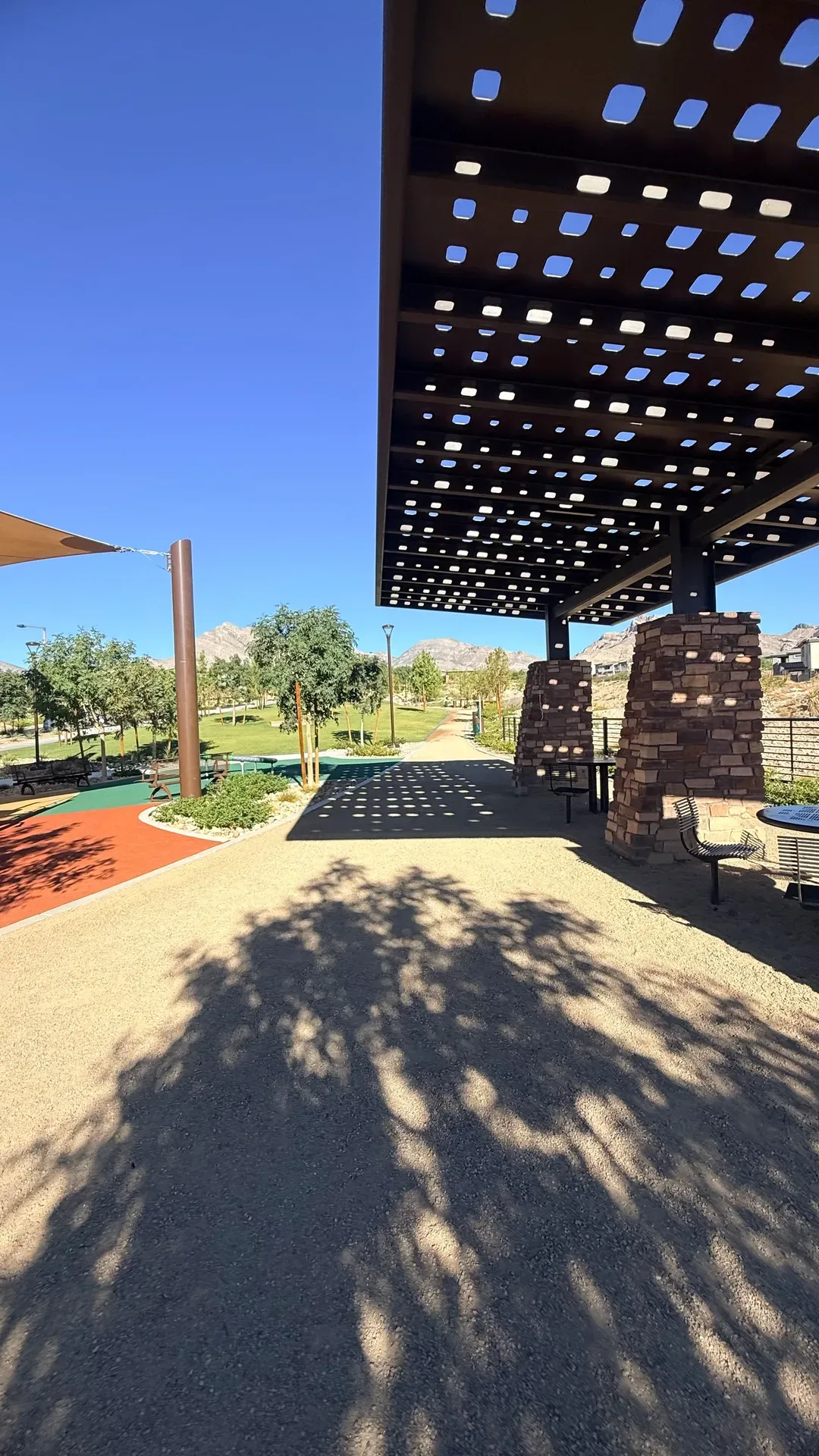 Shaded park seating area under a modern shade structure in a Summerlin park