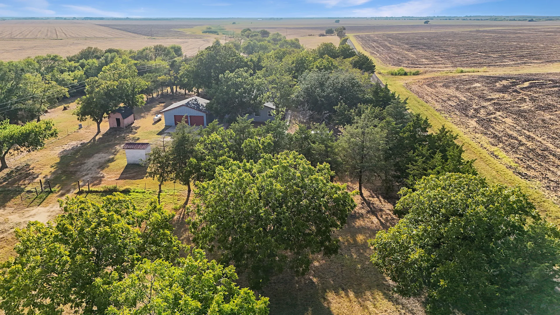 Drone aerial looking down over the homestead, outbuildings and surrounding fields on the tract