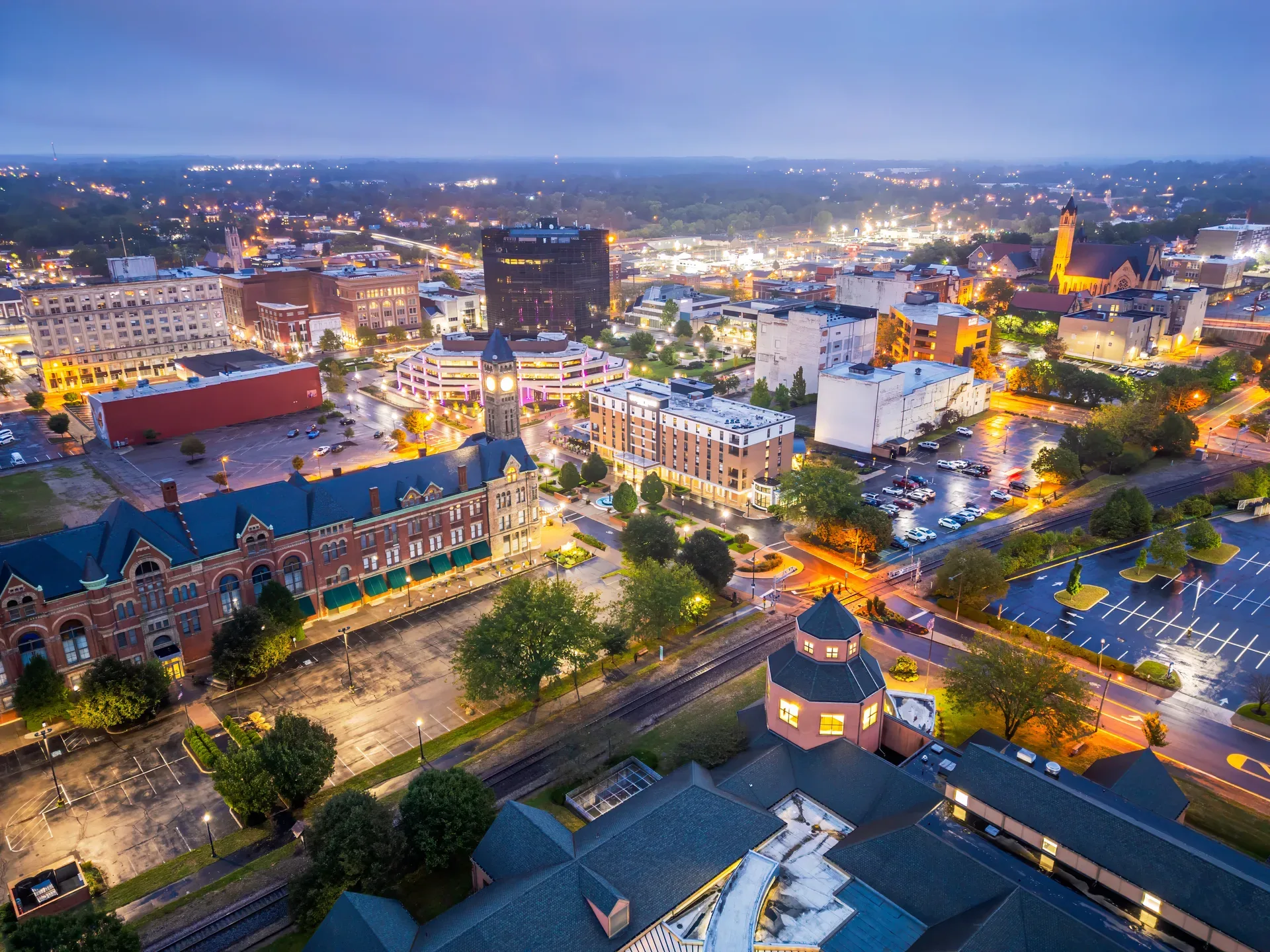 Springfield Ohio at twilight, an aerial blue-hour view of the city lights used as the hero backdrop for Glasshouse Realty's Columbus and Springfield office