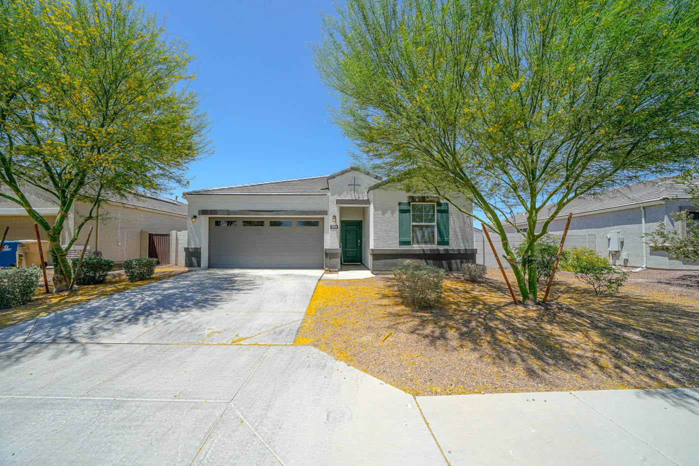 Single-story stucco home with desert landscaping