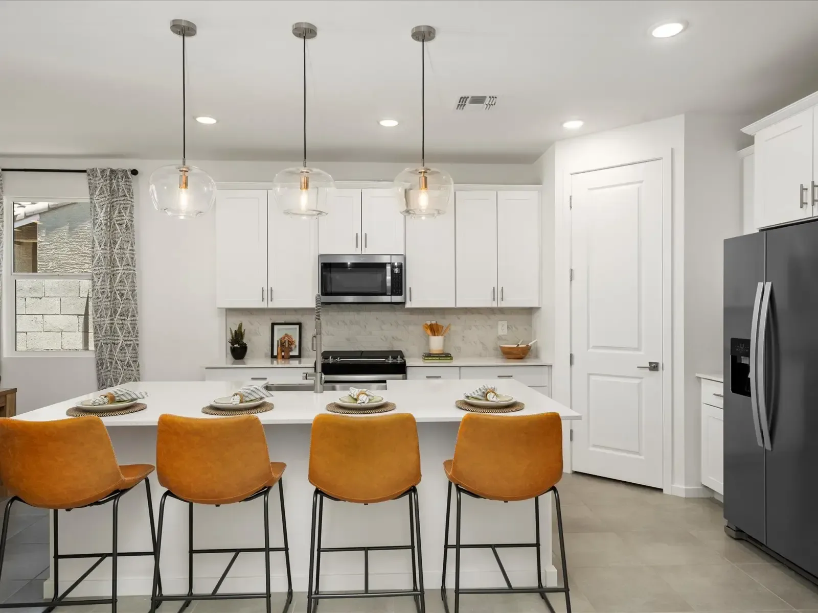 A bright, clean modern kitchen with white cabinetry