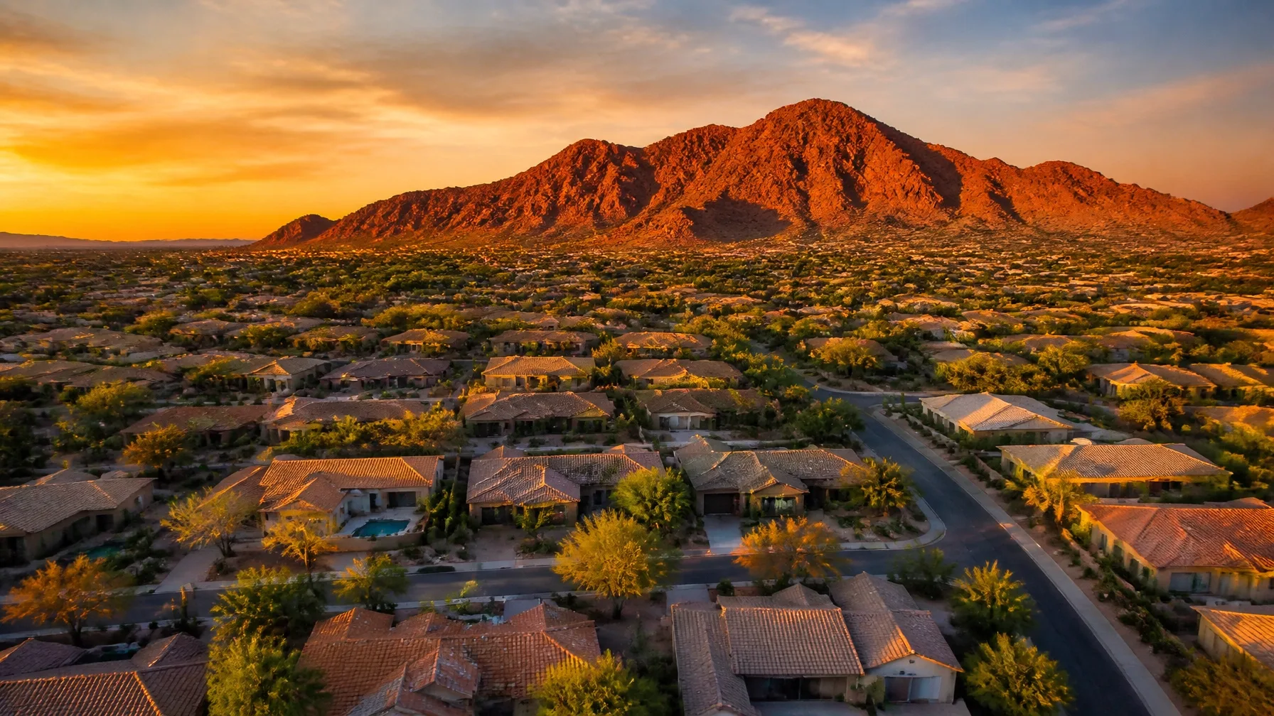 Aerial view of a West Valley residential neighborhood at sunset with mountains in the distance