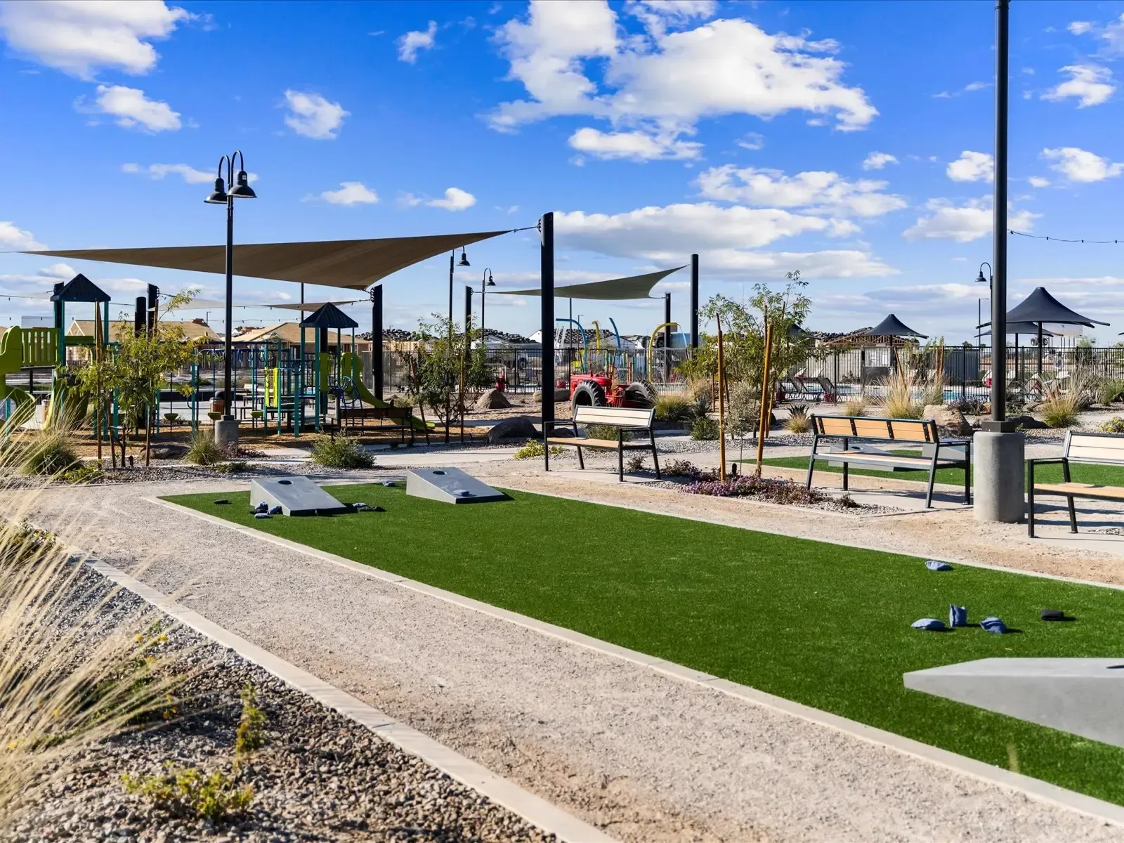 Community recreation area with a playground and shade sails in a sunny West Valley park