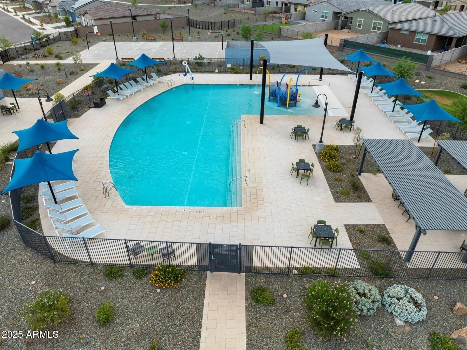Community pool and recreation area with shade sails in a resort-style community