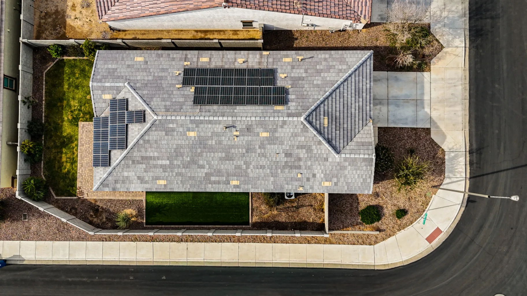 Aerial view of a suburban Arizona home with rooftop solar panels