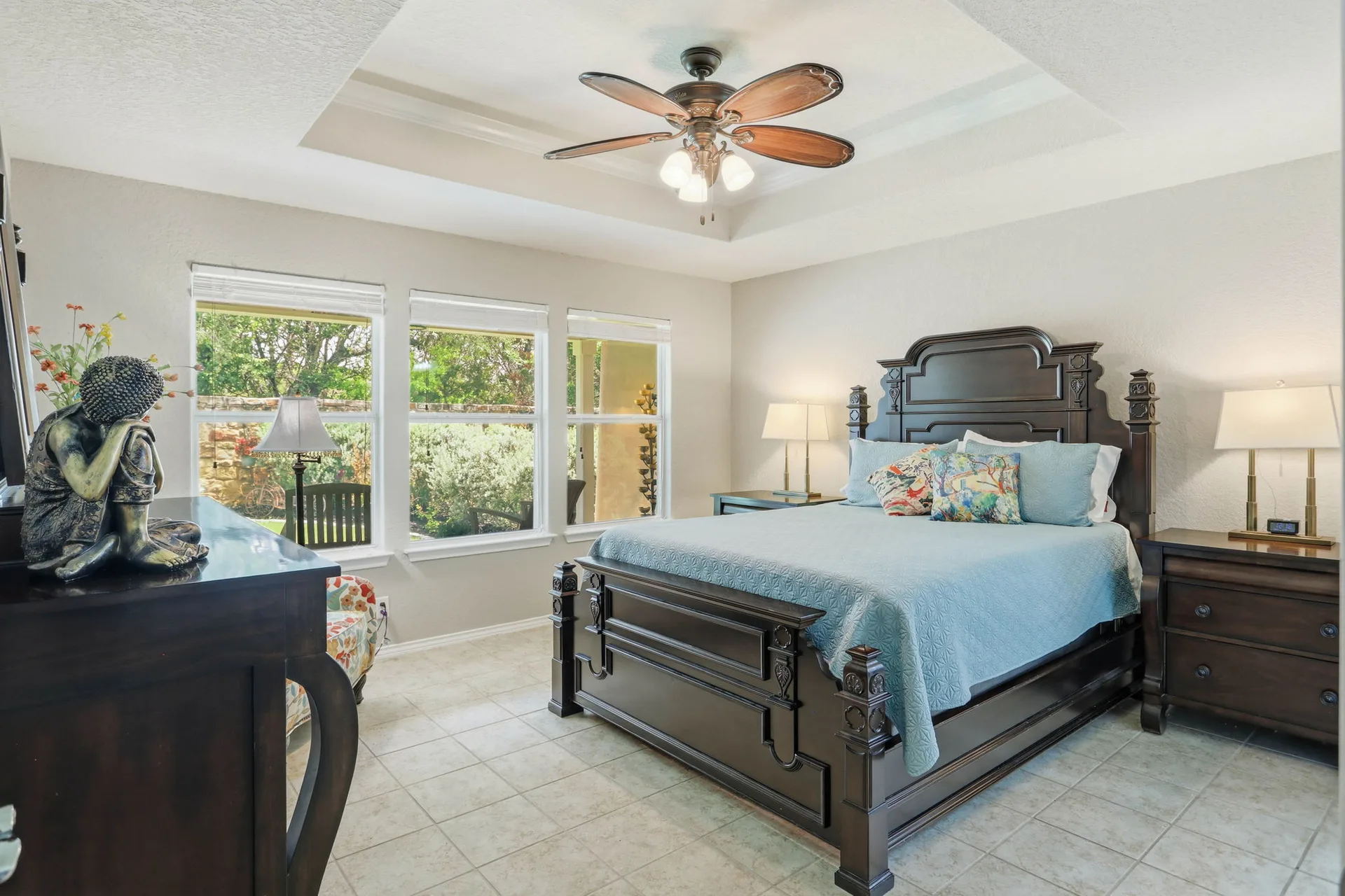 Primary bedroom with tray ceiling looking toward the backyard