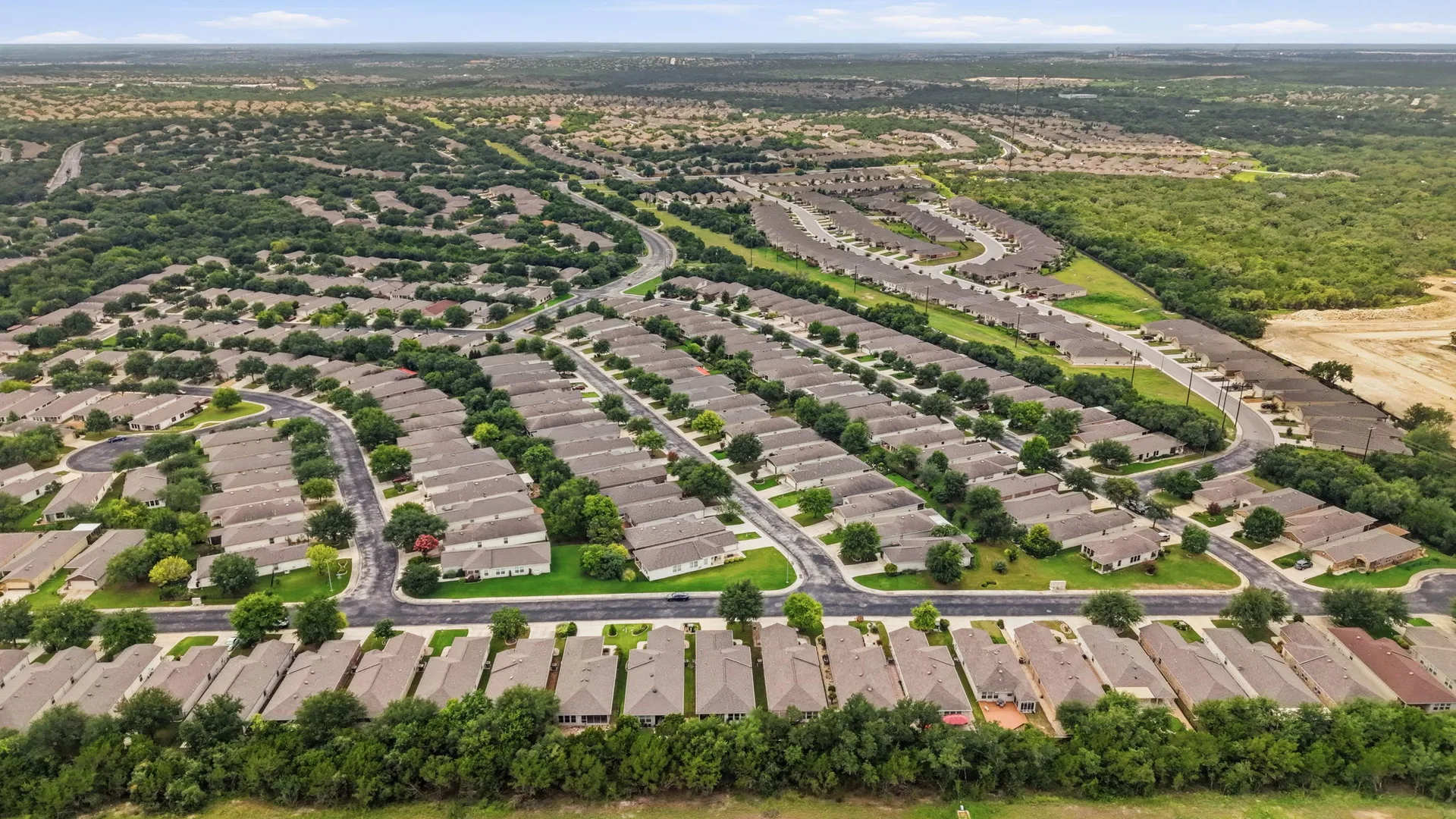 Aerial view of the Hill Country Retreat community with single-story homes and green space