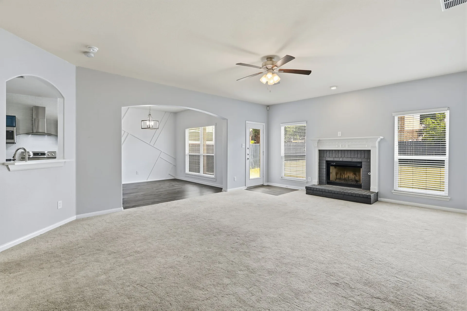 Living room with fireplace and bright windows