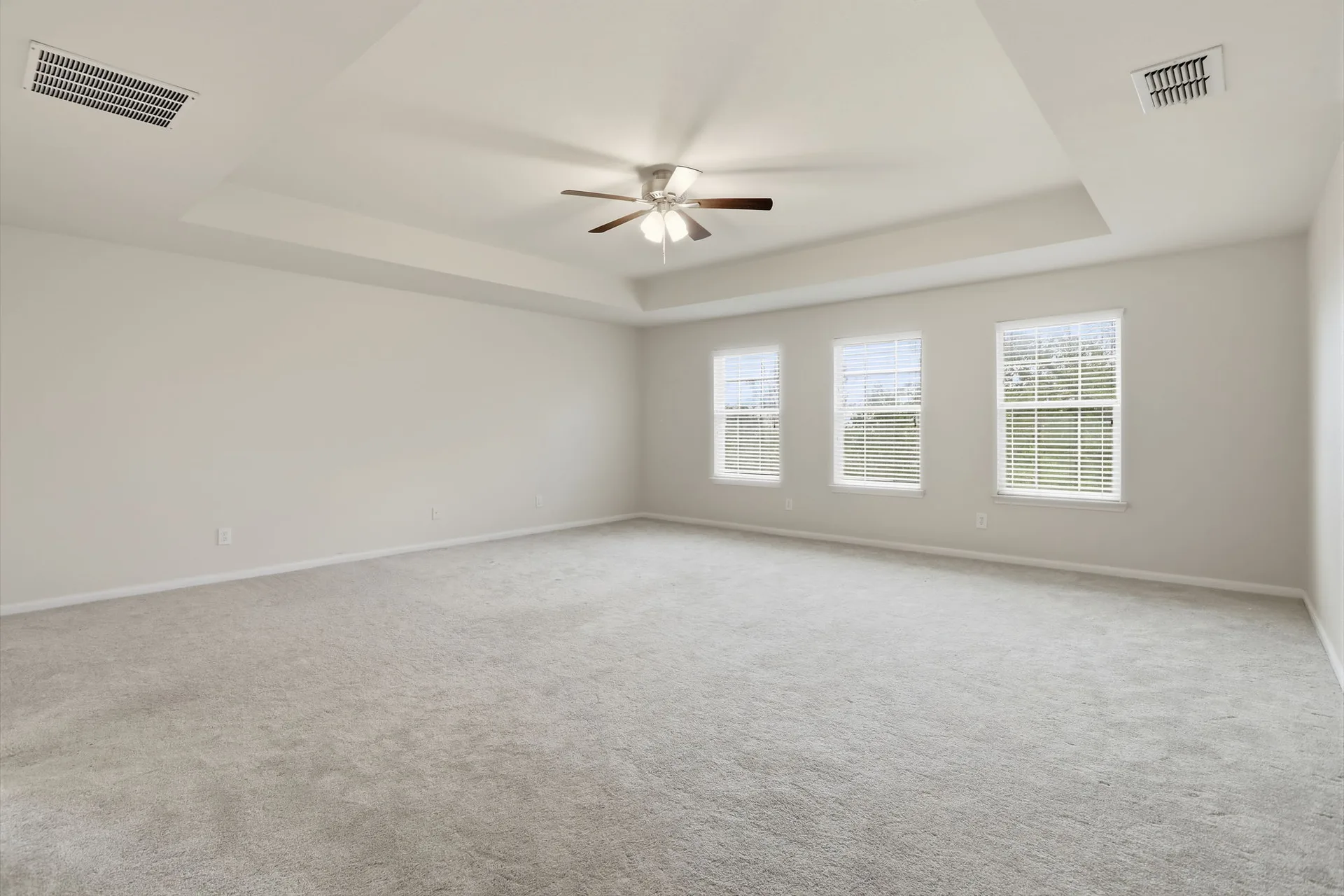 Primary bedroom with a tray ceiling