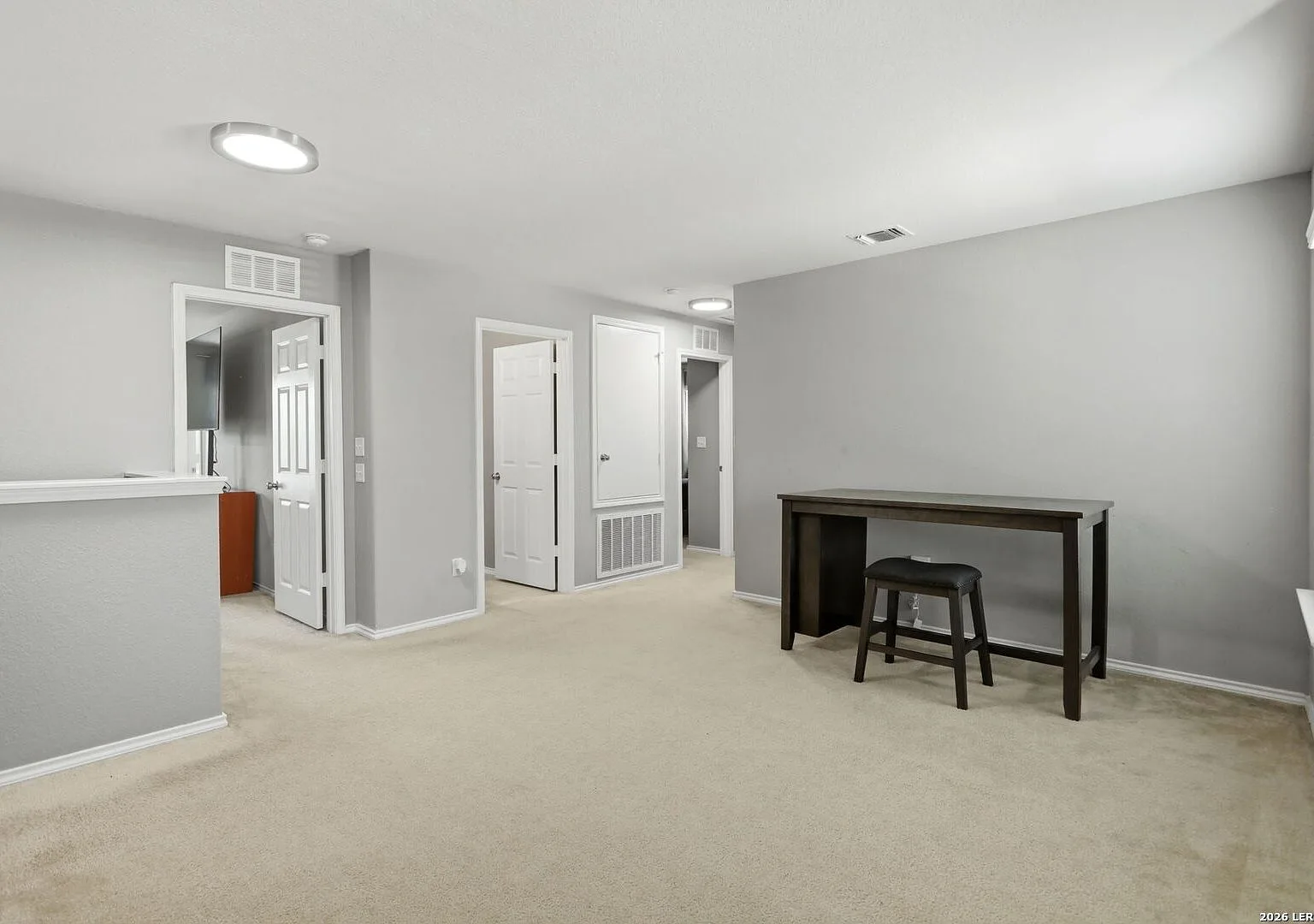 Upstairs game room landing with flush-mount ceiling lights.