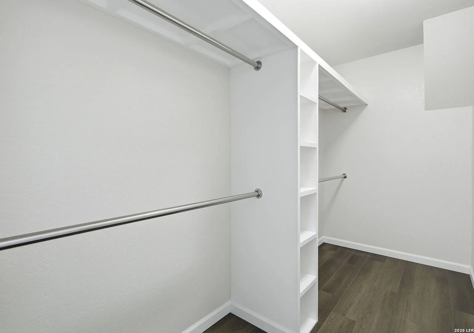 Walk-in closet with built-in shelving and organizers.