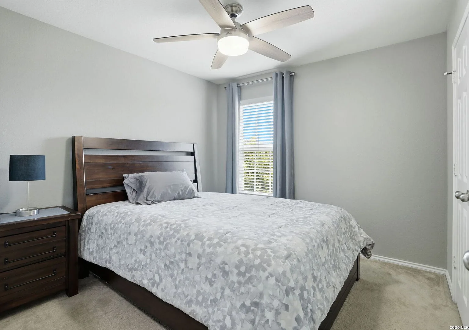 Secondary bedroom with a window and neutral decor.