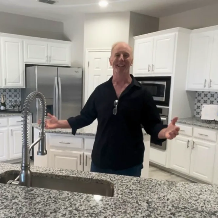 A bright modern kitchen with white cabinetry, a home Patrick helps buyers evaluate and finance