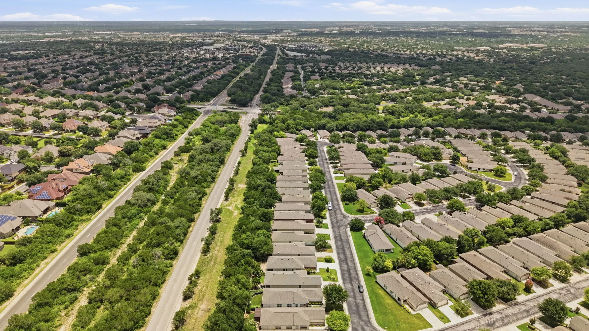 High-altitude view of Alamo Ranch, the master-planned community around 12827 Sand Holly