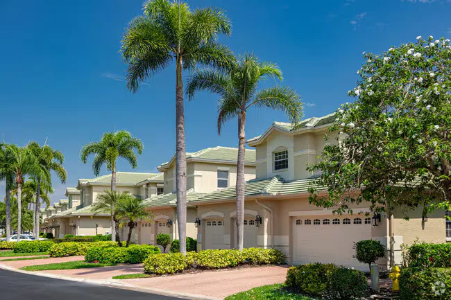 Luxury townhomes in The Vineyards with tropical landscaping and attached garages