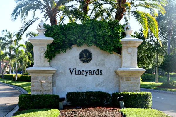 The Vineyards community entrance sign with Mediterranean stone facade and palm landscaping