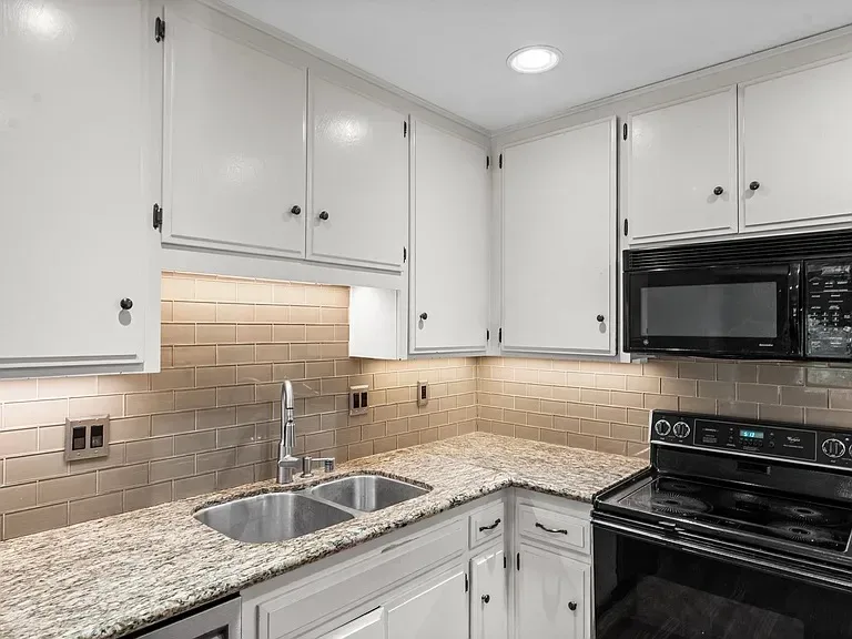 Freshly updated kitchen counters and cabinets at 140 Walnut Ave, Unit 2F