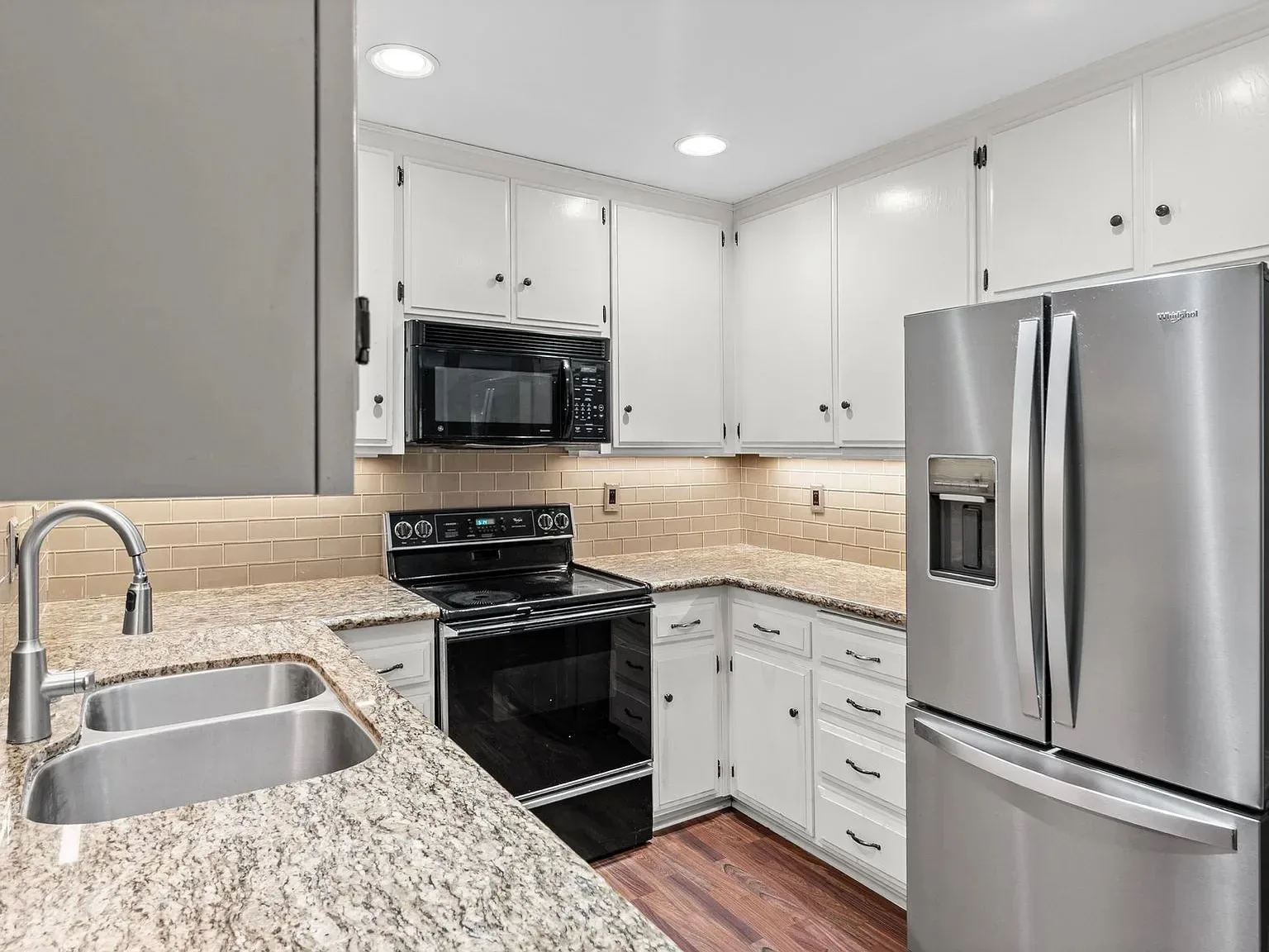 Updated kitchen interior with a brand-new range and microwave in the Bankers Hill rental