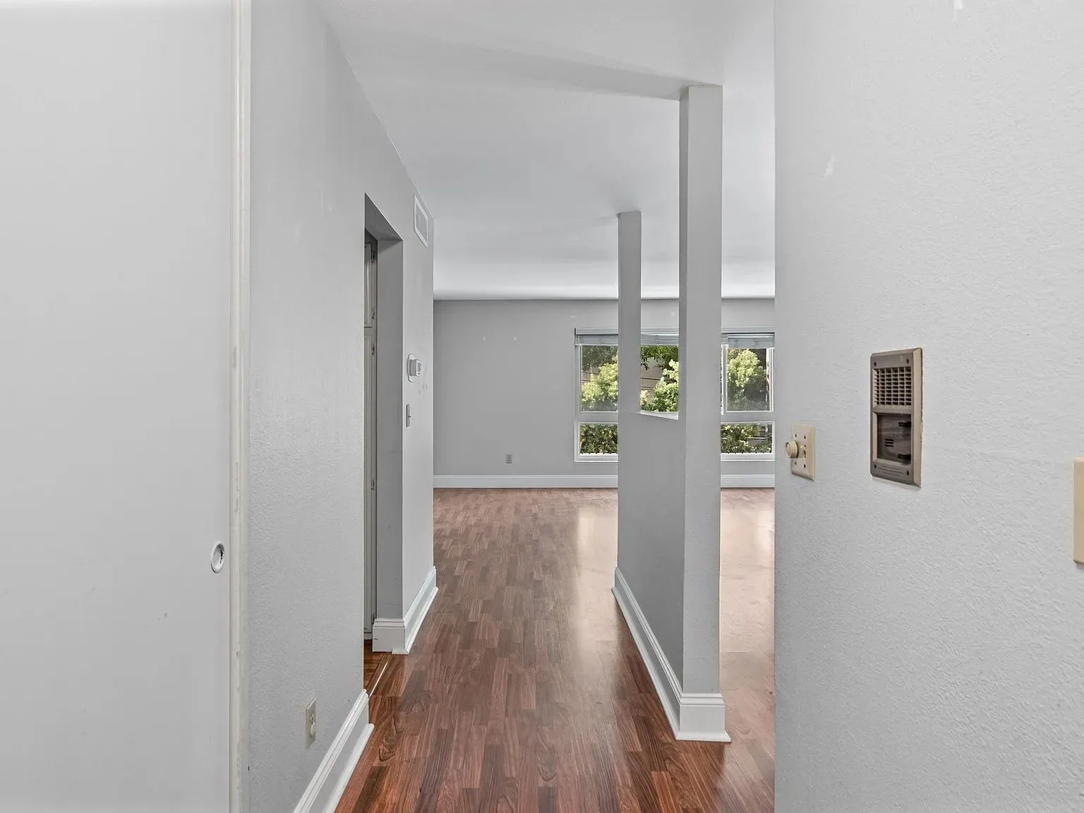 Light-filled living room and entry hallway at 140 Walnut Ave, Unit 2F
