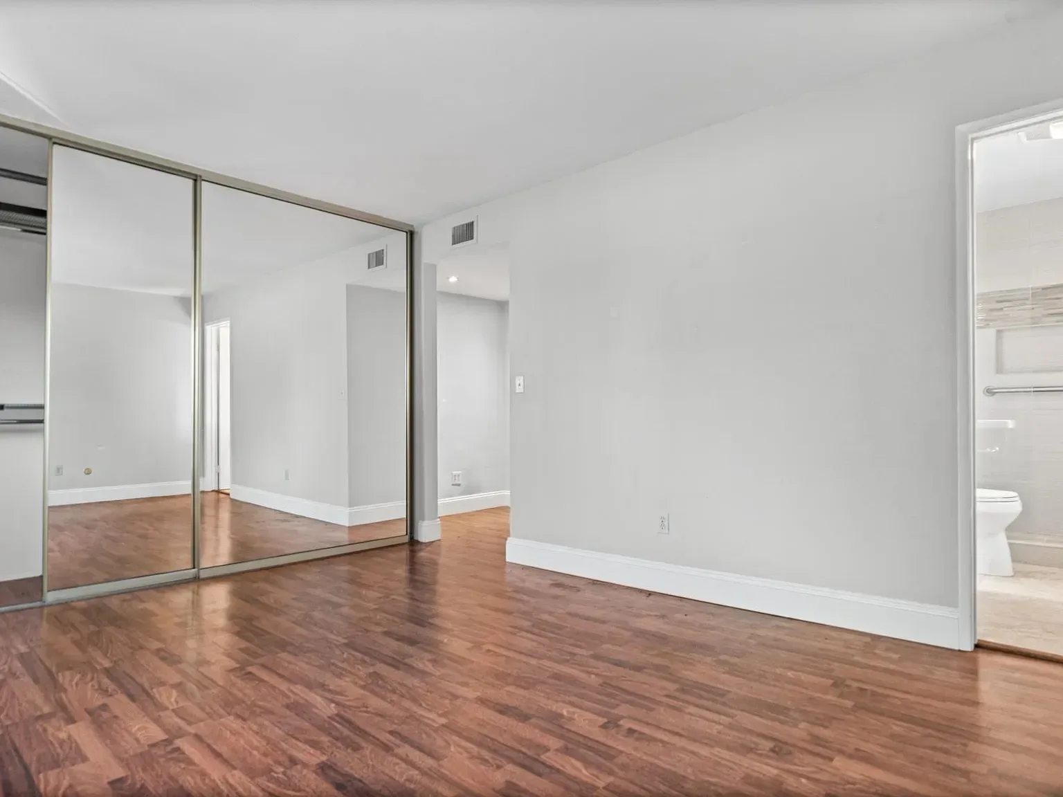 Master bedroom with mirrored closet at 140 Walnut Ave, Unit 2F
