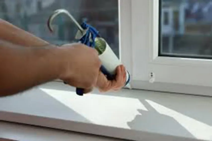 Door handle repair by a handyman in San Antonio: brushed-metal door hardware being installed on a wood door with a screwdriver for Alamo Ranch homeowners