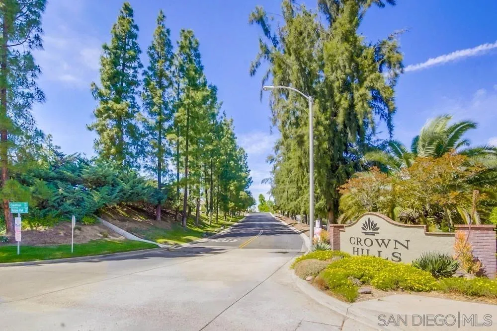 Crown Hills community entrance sign along the road into the Alpine community