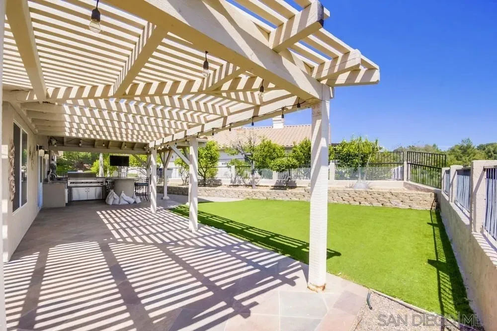 Covered backyard patio with pergola at 2703 Lobelia Road in Alpine