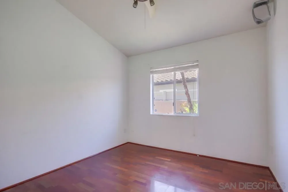 Vacant bedroom with hardwood floors at 2703 Lobelia Road