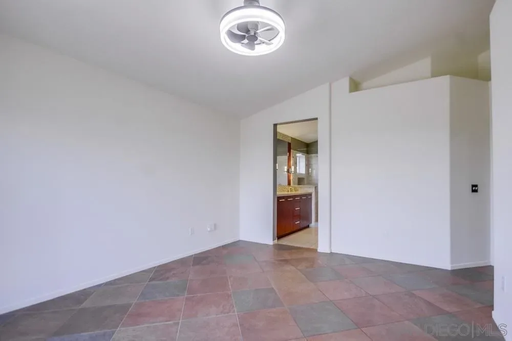 Master bedroom with tile flooring at the Lobelia Road home