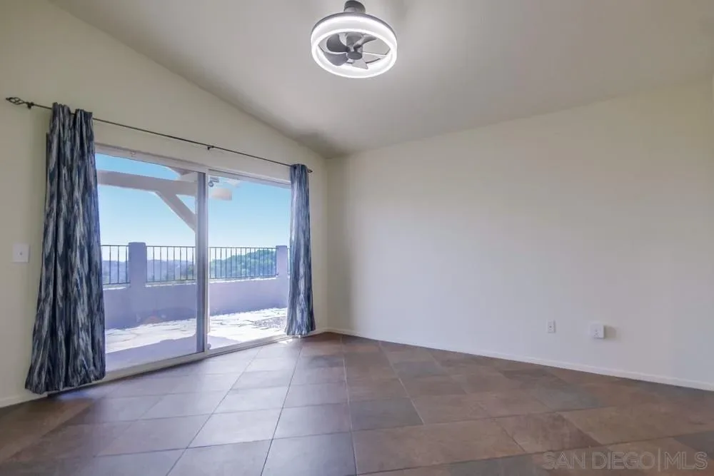 Master bedroom with sliding door at the Alpine one-story home