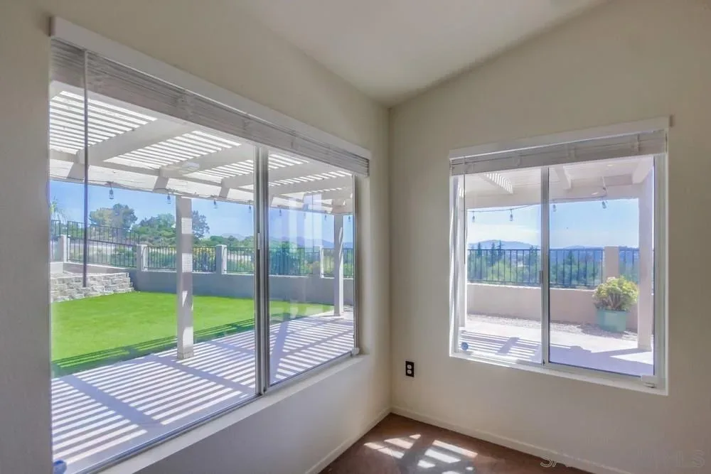 Sunroom view toward the covered patio and hillside at the Crown Hills home