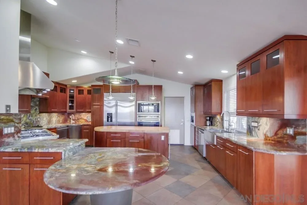 Kitchen with cherry wood cabinetry and granite countertops at the Crown Hills home