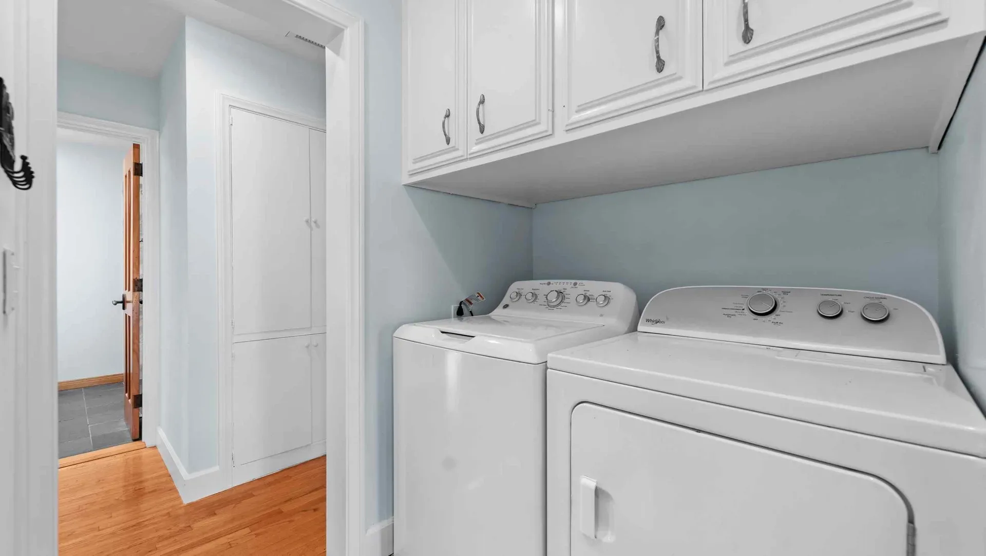 Laundry room with white cabinetry at 425 Neptune Ave