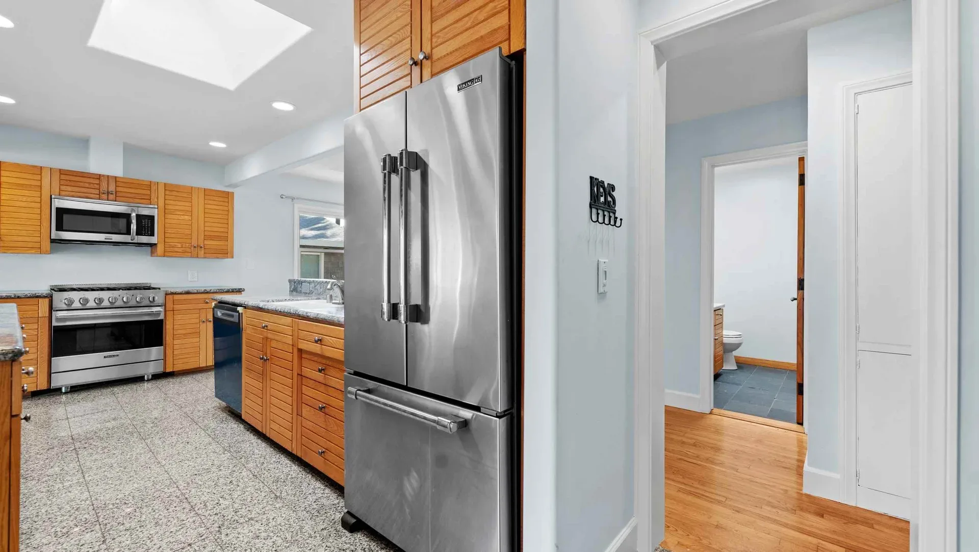 Kitchen with slatted wood cabinetry and a skylight at 425 Neptune Ave