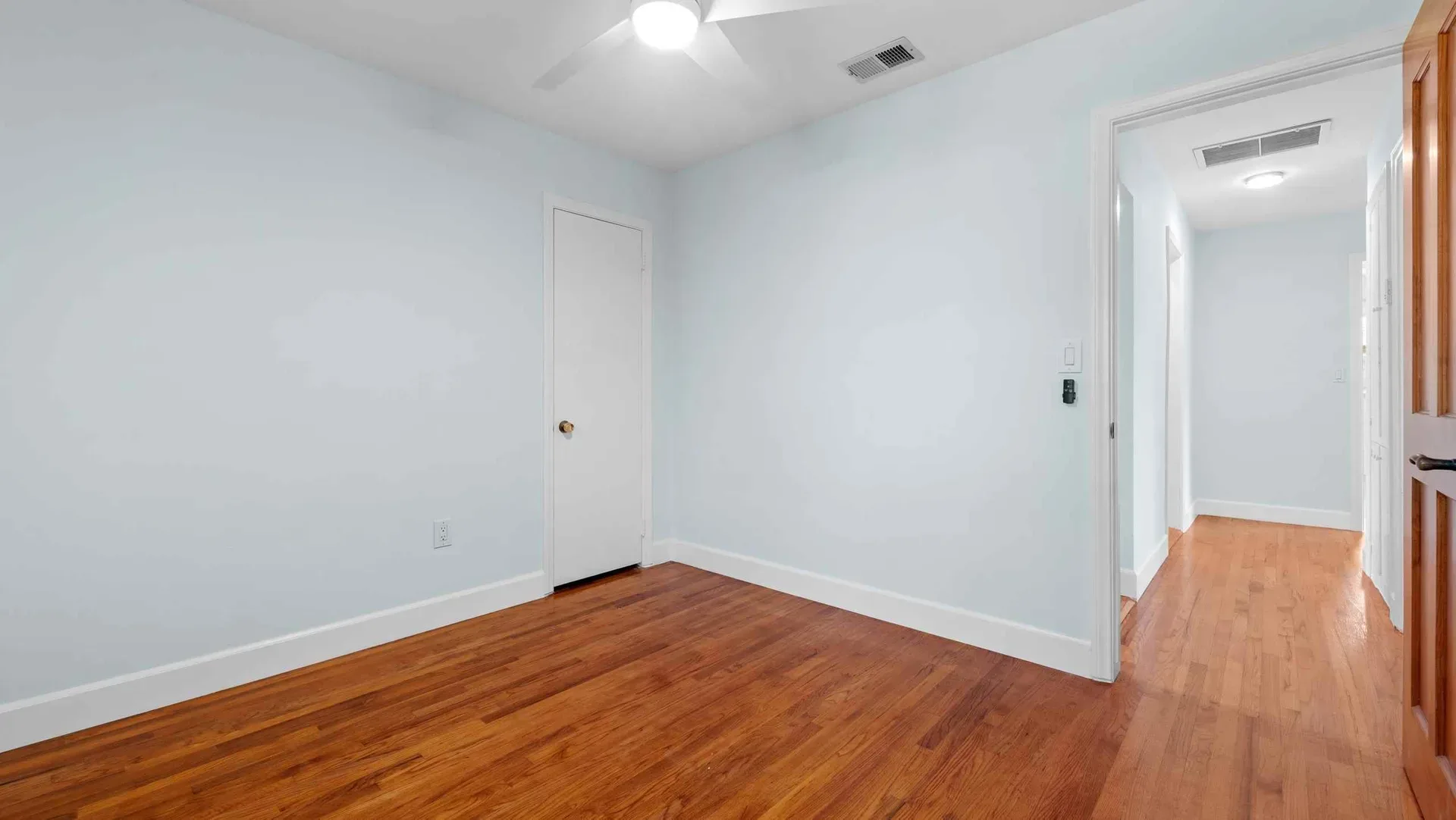 Secondary bedroom with hardwood floors at the Encinitas bungalow