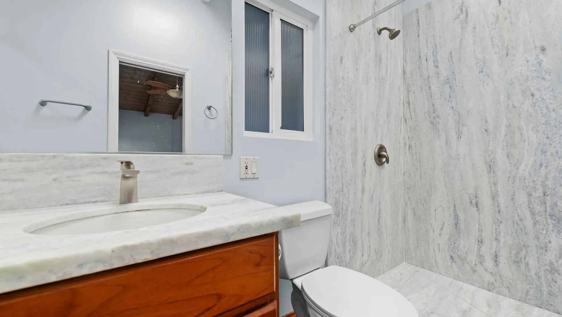 Bathroom with a marble vanity and walk-in shower at 425 Neptune Ave