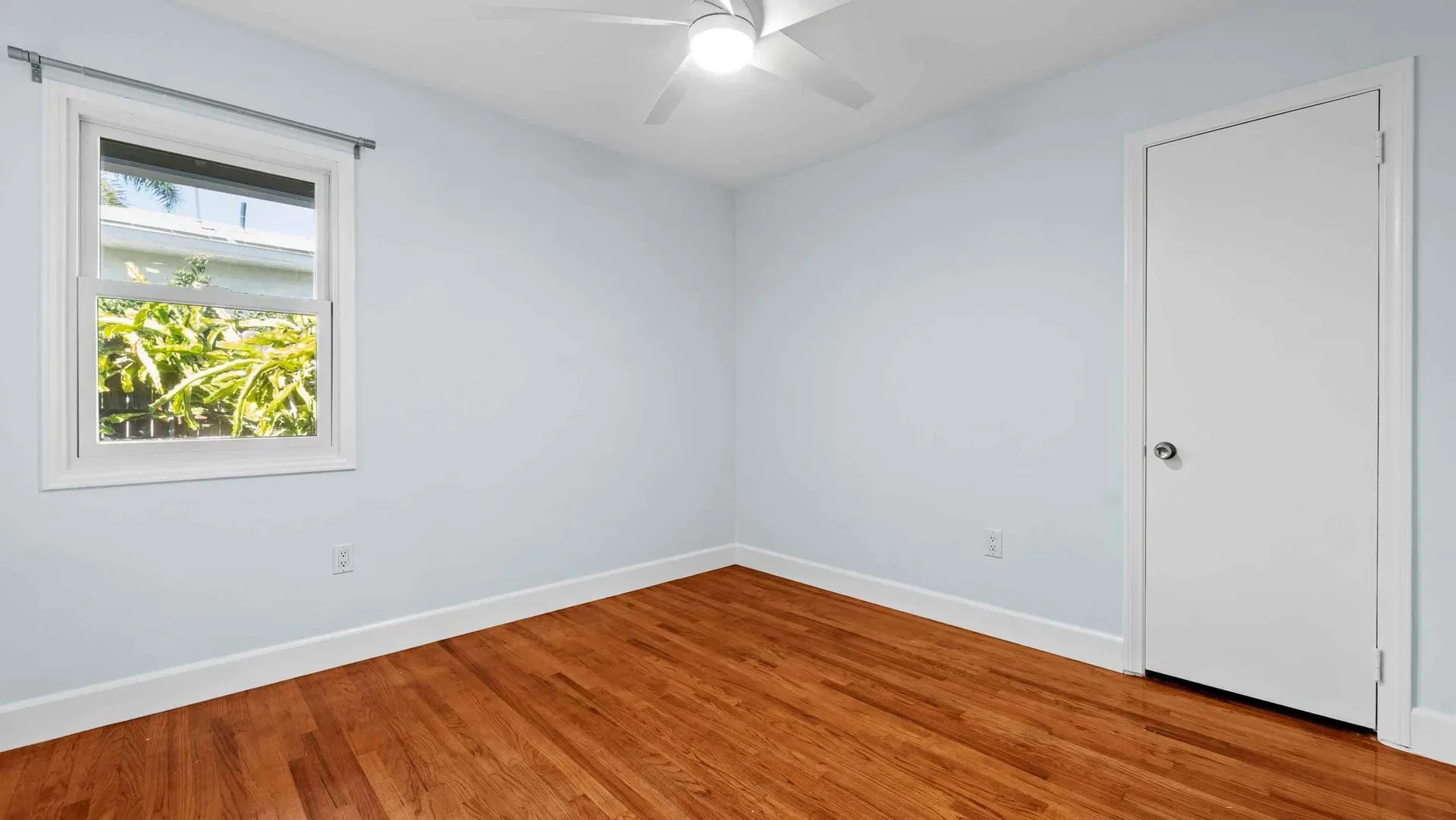 Small bedroom with hardwood floors and natural light at 425 Neptune Ave