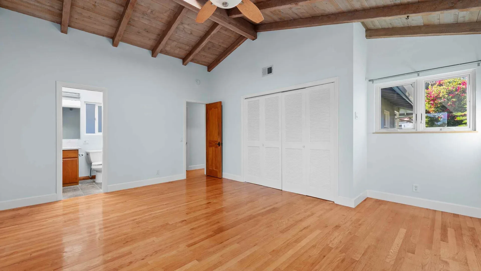 Bedroom with a vaulted wood-beam ceiling at 425 Neptune Ave