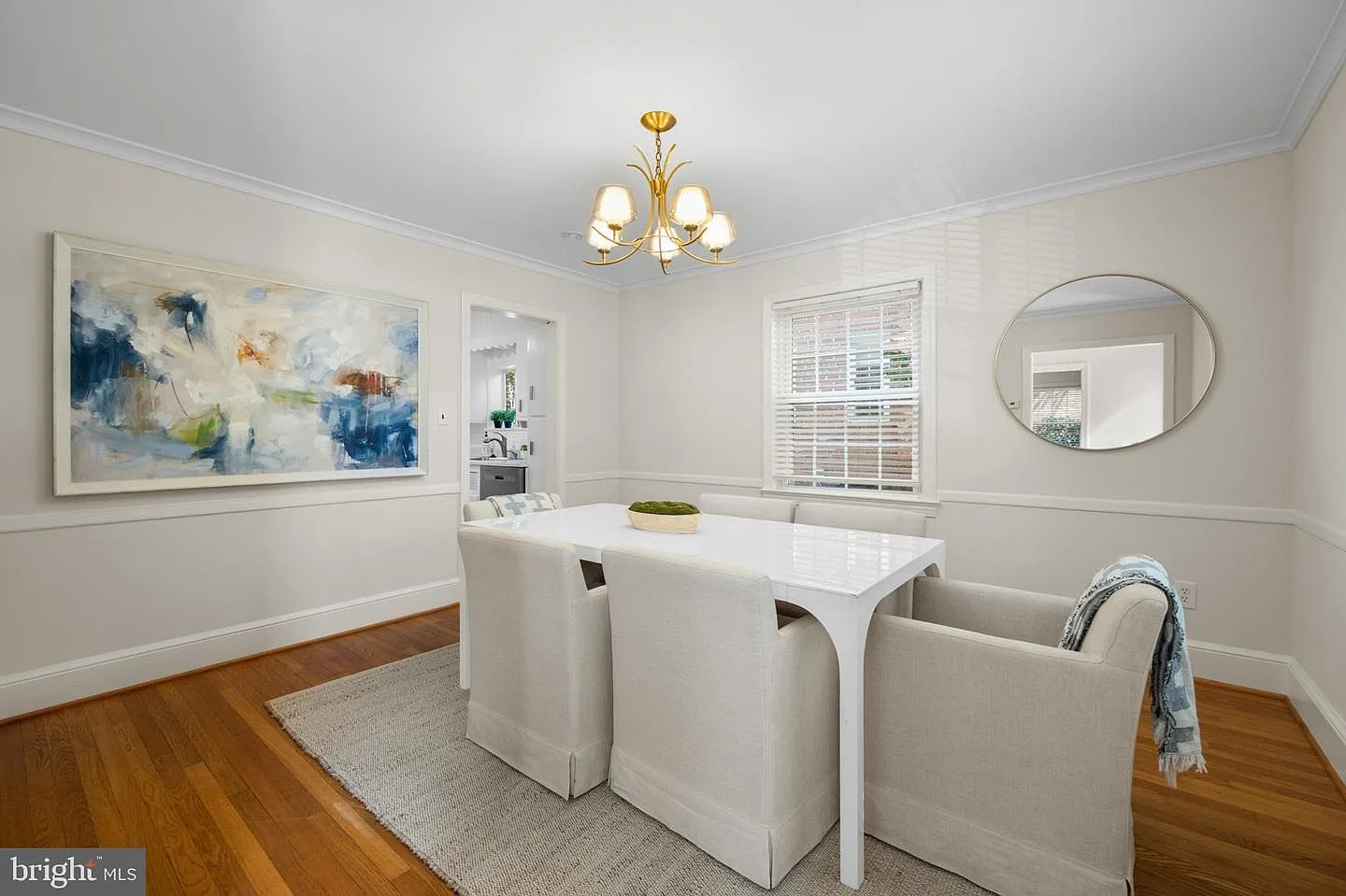 Formal dining room with white wainscoting and hardwood floors
