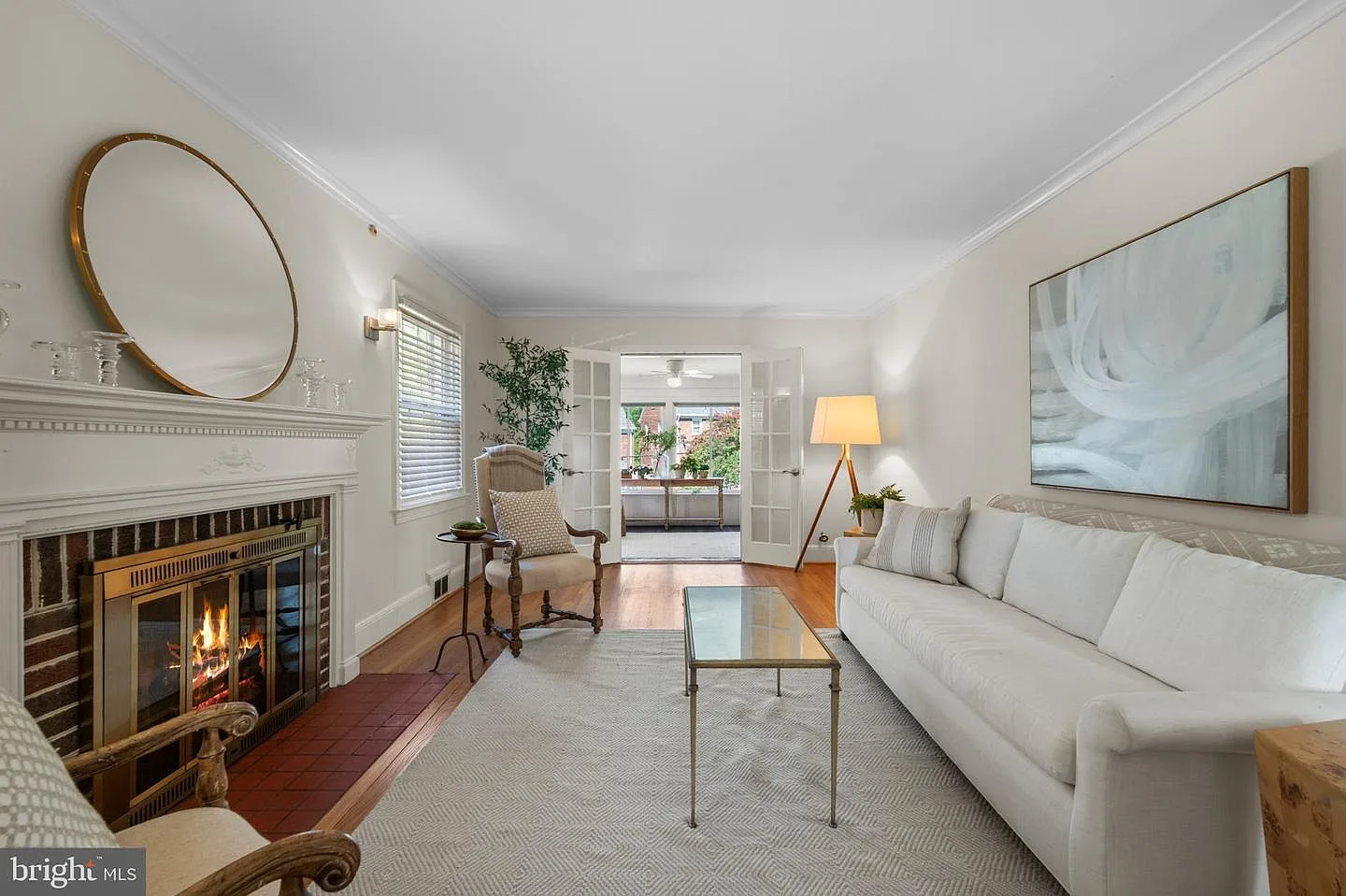 Living room fireplace with glass doors and a classic mantel